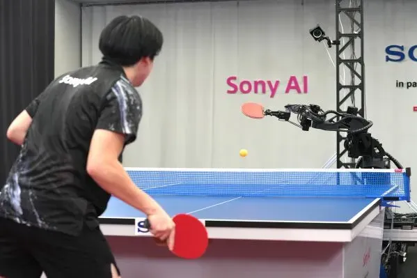 روبوت Ace من Sony يتحدى لاعب تنس طاولة محترف، حيث يظهر الروبوت بوضوح وهو يستعد لضرب الكرة في ملعب مخصص.