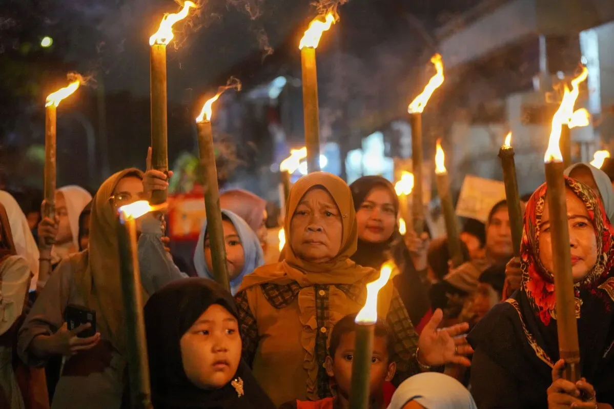 مشاركون يحملون المشاعل في موكب "ترحيب رمضان" في تانجيرانغ، إندونيسيا، احتفالًا ببدء شهر الصيام الإسلامي.