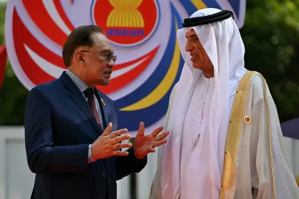 اجتماع بين رئيس الوزراء الماليزي أنور إبراهيم وولي العهد الكويتي الشيخ صباح خالد الصباح في قمة آسيان، مع شعار آسيان خلفهما.