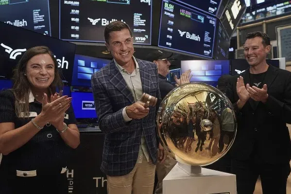 احتفال فريق Bullish بإدراجهم في البورصة، مع عرض لقطعة فنية تعكس نجاحهم في السوق المالية.