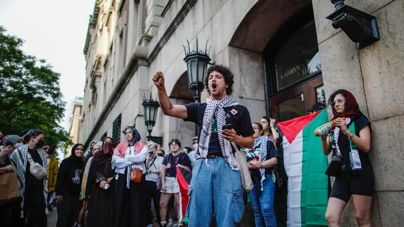 محتجون يحملون الأعلام الفلسطينية في جامعة كولومبيا، يعبرون عن دعمهم للقضية الفلسطينية وسط أجواء من التوترات الأكاديمية.