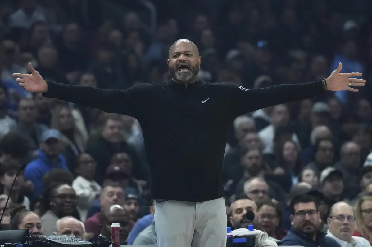 مدرب كليفلاند كافالييرز يتفاعل بحماس خلال مباراة ضد ديترويت بيستونز، حيث يظهر حشد من المشجعين في الخلفية.
