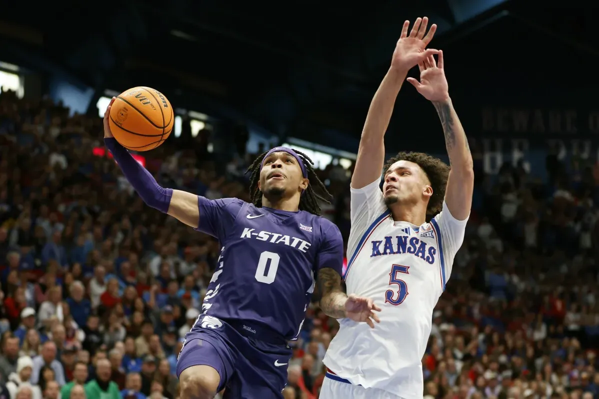تسديدة لاعب K-State بينما يحاول لاعب كانساس معاقبته في مباراة مثيرة ضمن دوري كرة السلة الجامعية.