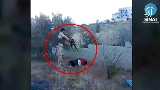 تظهر الصورة مقاتلاً مسلحًا يستعد لإطلاق النار على شخص مستلقي على الأرض، مما يعكس مشاهد من النزاع في سيناء.