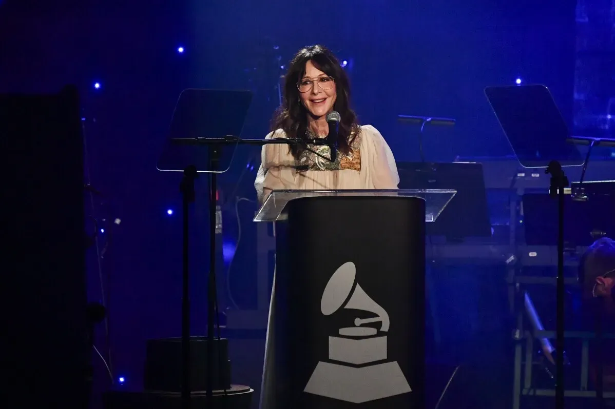 تظهر جودي جيرسون، الرئيس التنفيذي لمجموعة Universal Music Publishing، أثناء إلقاء كلمتها في حفل غرامي لجمع التبرعات، محاطة بأضواء زرقاء.