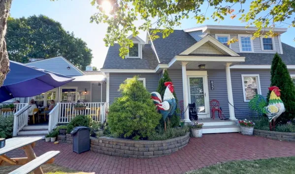 منزل في بلدة Ogunquit مع تماثيل ديكة معدنية عملاقة في الحديقة، تعبيراً عن دعم طفلة مصابة بالتوحّد.