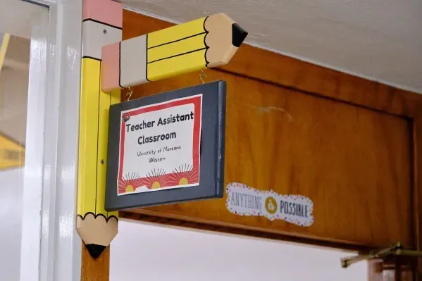 لافتة تشير إلى فصل مساعد المعلم في مدرسة مورنينغسايد الابتدائية، تبرز شراكة جامعة مونتانا-ويسترن مع البرنامج التعليمي.