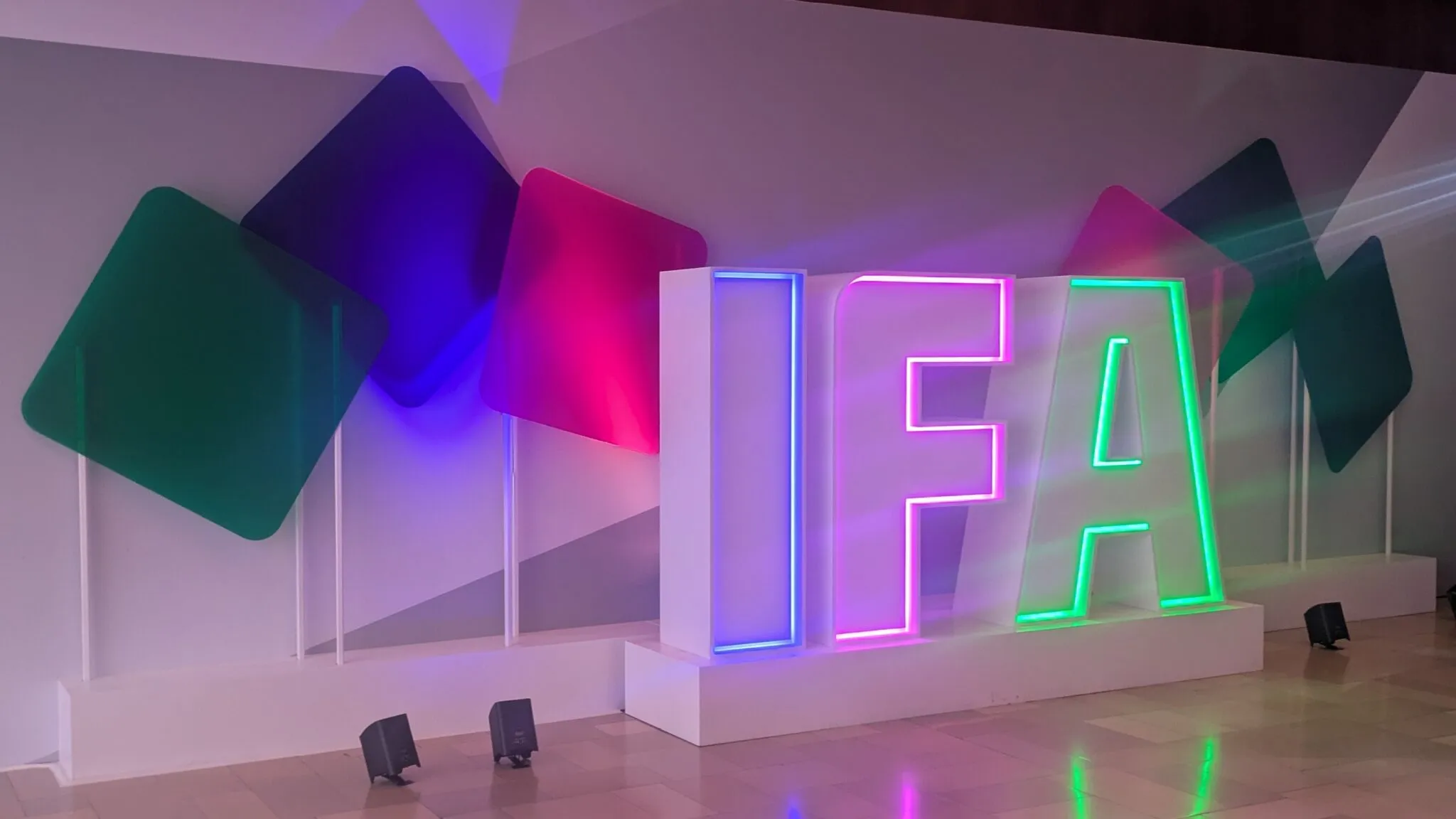 شعار معرض IFA مضاء بألوان زاهية في قاعة برلين، يعكس تركيز المعرض على التكنولوجيا الحديثة والاستدامة البيئية.