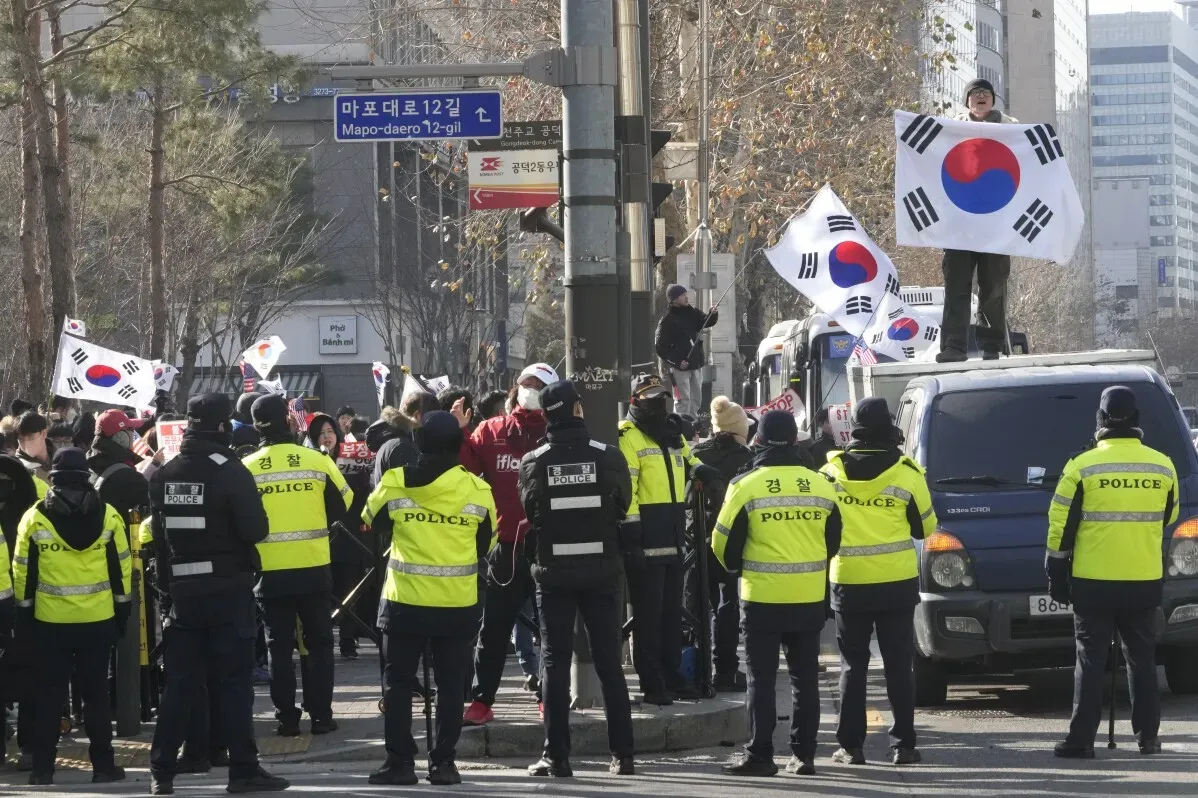 تظهر الصورة تجمع حشود من المؤيدين في سيؤول، حيث يحمل البعض أعلام كوريا الجنوبية في سياق الاحتجاجات ضد اعتقال الرئيس المعزول.