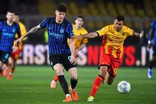 لاعبان يتنافسان على الكرة في مباراة كرة قدم، أحدهما يرتدي قميصًا أزرق بينما الآخر يرتدي قميصًا أصفر، وسط أجواء حماسية.