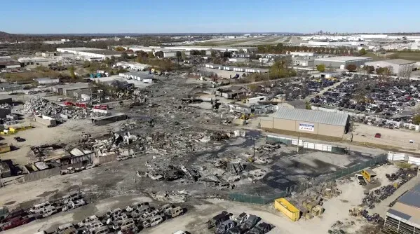 مشهد جوي لموقع تحطم طائرة UPS في لويزفيل، يظهر الأضرار الكبيرة في المنطقة مع بقايا الحطام والمباني المحيطة.