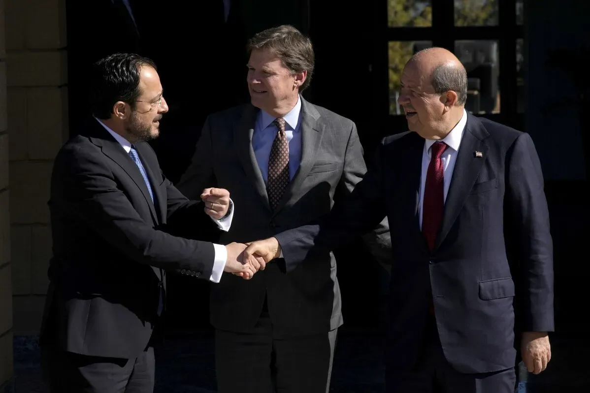 اجتماع الزعيمين القبرصيين حول فتح نقاط عبور جديدة عبر المنطقة العازلة، حيث يتصافحون معًا أمام مقر بعثة الأمم المتحدة.