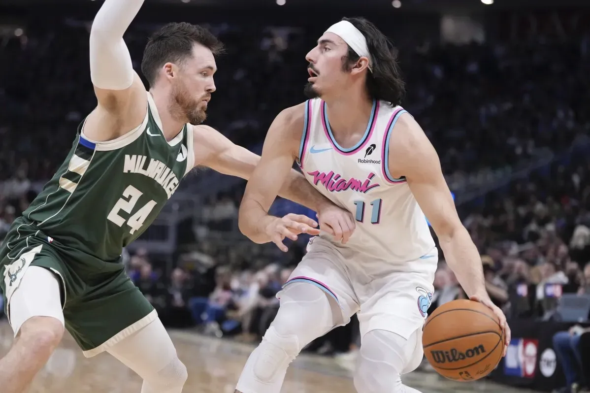 منافسة رياضية بين لاعب من ميلووكي باكس وآخر من ميامي هيت خلال مباراة سلة، حيث يحاول اللاعب من هيت التوغل بالكرة.
