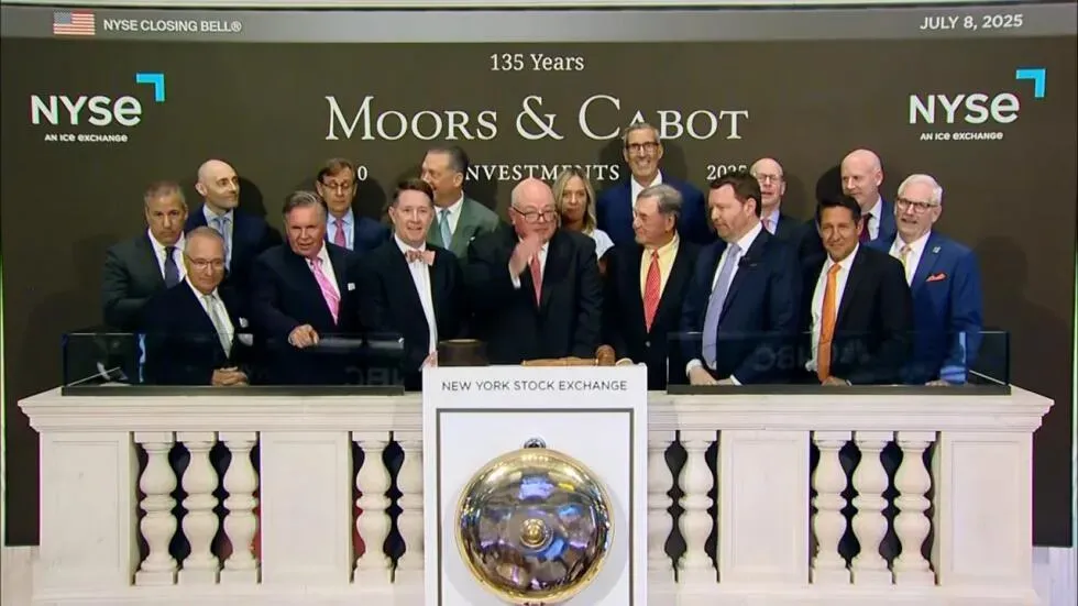 احتفال جماعي في بورصة نيويورك بمناسبة الذكرى 135 لشركة Moors & Cabot، حيث يتجمع عدد من الشخصيات البارزة حول الجرس.