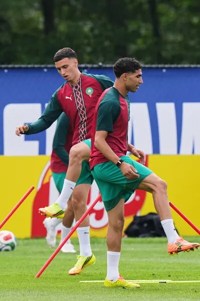 أشرف حكيمي يتدرب مع زملائه في المنتخب المغربي، استعدادًا لمباريات كأس العالم، وسط أجواء تنافسية وتحضيرات مكثفة.