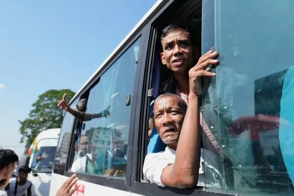 سجناء يلوحون بأيديهم من نافذة حافلة أثناء نقلهم بعد الإفراج عنهم في ميانمار، بمناسبة الذكرى الثامنة والسبعين لاستقلال البلاد.