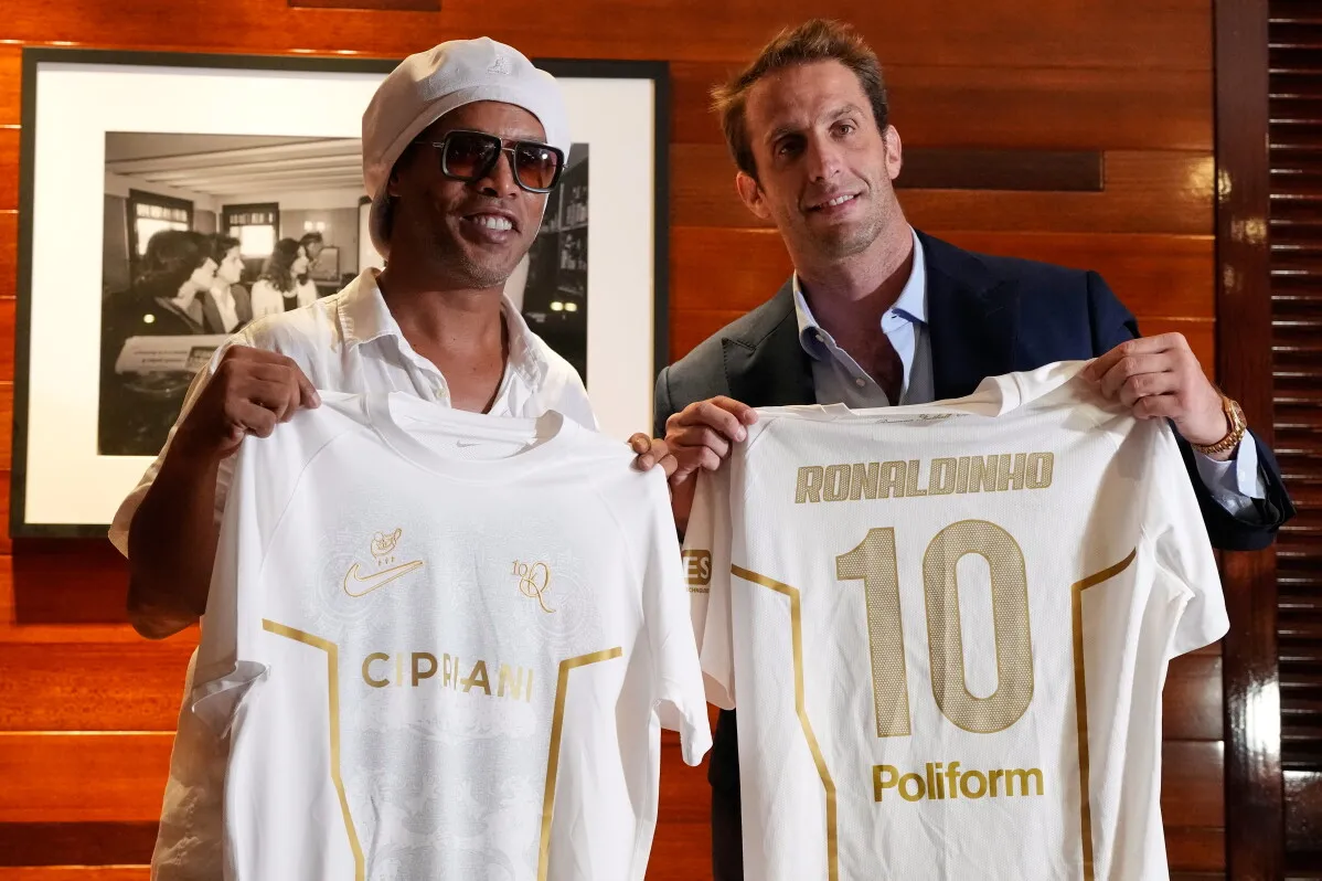 رونالدينيو يحمل قميص نادي رافينا الإيطالي خلال حفل تقديمه، مع المدير التنفيذي إغنازيو تشيبرياني، في أجواء احتفالية.