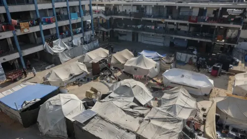 مخيمات مؤقتة في ساحة محاطة بمبانٍ متعددة الطوابق، حيث يعيش اللاجئون في ظروف صعبة بعد النزاع في غزة.