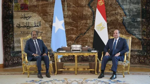 الرئيس المصري عبد الفتاح السيسي ورئيس الصومال حسن شيخ محمود يجلسان أمام أعلام بلديهما في اجتماع لتعزيز التعاون البحري والموانئ.