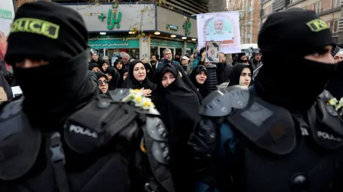 محتجون في إيران يتجمعون خلال مظاهرة، مع وجود قوات الأمن في المقدمة، وسط تدهور الأوضاع الاقتصادية واحتجاجات ضد الحكومة.