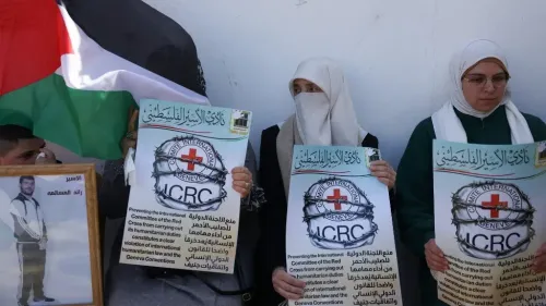نساء فلسطينيات يحملن لافتات احتجاجية ضد منع اللجنة الدولية للصليب الأحمر من زيارة المعتقلين الفلسطينيين في السجون الإسرائيلية.