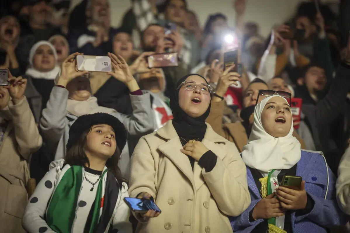 حضور حماسي في حفلة وصفي المعصراني بدمشق، حيث يغني الجمهور ويهتف، مع العلم السوري الجديد يرفرف في الأيدي.