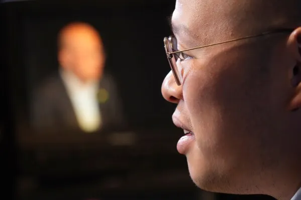 صورة تُظهر Sebastien Lai، نجل الناشط الديمقراطي Jimmy Lai، وهو يتحدث بقلق عن قضيّة والده في سياق التوترات بين الولايات المتحدة والصين.