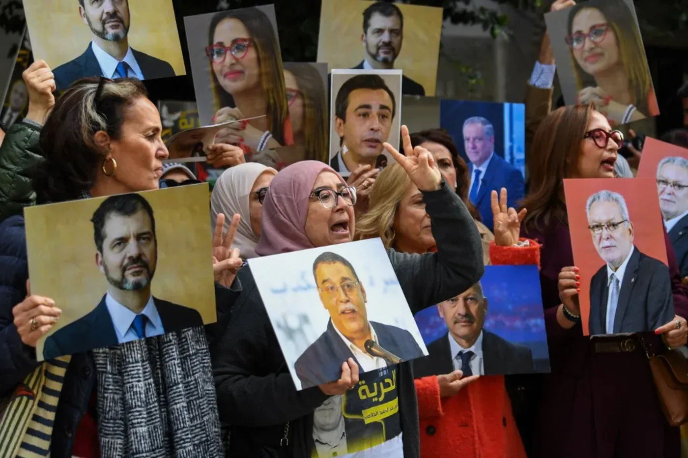تجمع حاشد في تونس يضم متظاهرين يحملون صور شخصيات سياسية معارضة، تعبيرًا عن رفضهم للمحاكمة المرتبطة بالتآمر ضد الدولة.