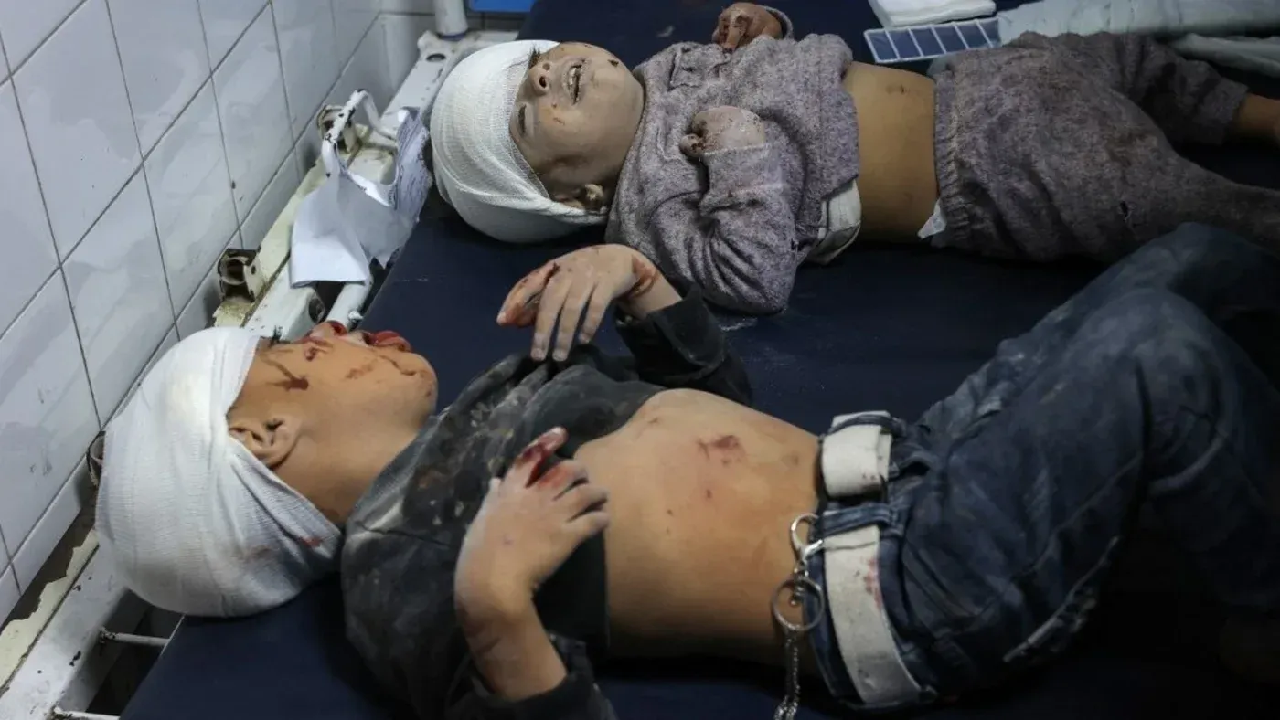 طفلان فلسطينيان مصابان يرقدان في مستشفى بغزة، مع إصابات وجروح واضحة، في سياق الأزمات الإنسانية الناجمة عن العدوان الإسرائيلي.