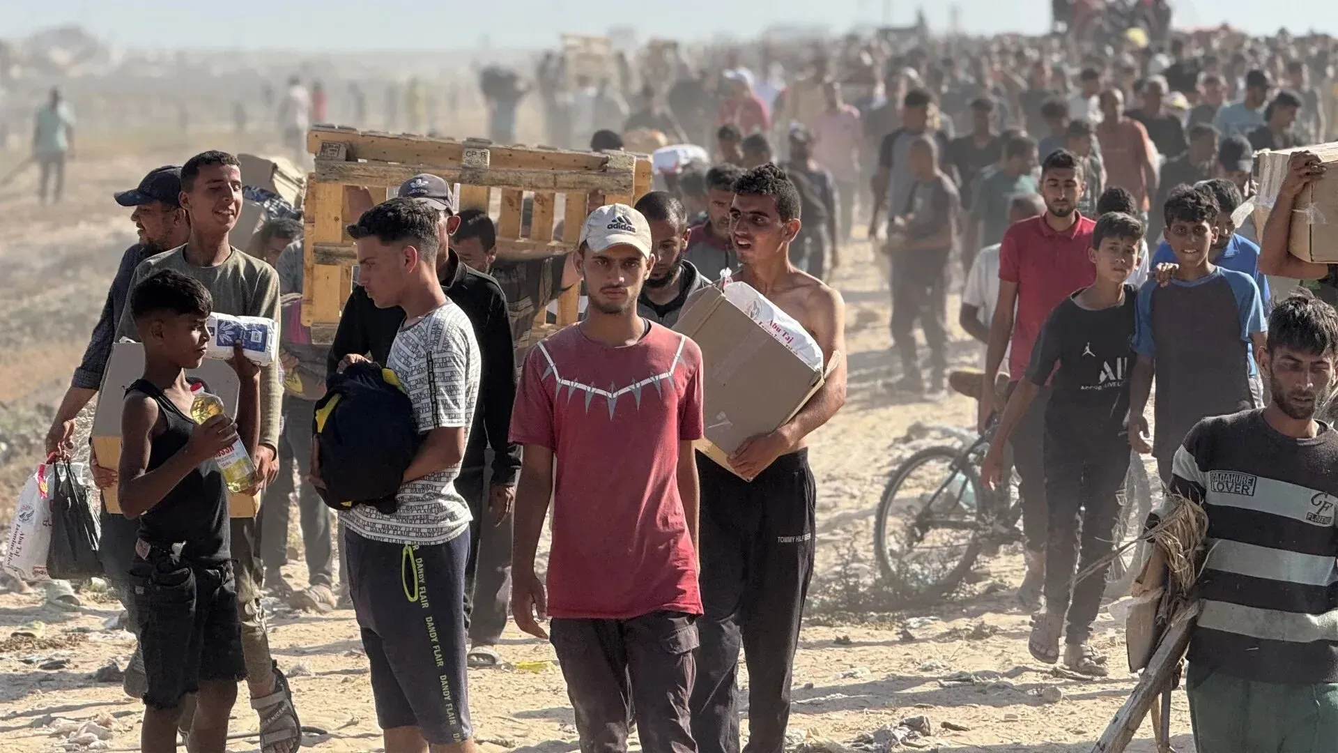 مشهد لفلسطينيين يتدافعون للحصول على المساعدات الإنسانية في رفح، جنوب قطاع غزة، وسط فوضى وصراخ، بعد مقتل ثلاثة أشخاص بنيران إسرائيلية.