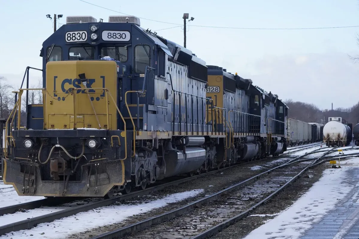 قطارات CSX المتوقفة على السكة الحديدية في بيئة شتوية، تعكس جهود الشركة في تحسين الكفاءة وزيادة الشحنات.