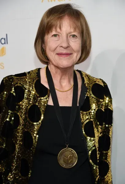 فائزة بجائزة الدائرة الوطنية لنقاد الكتاب، تظهر الكاتبة فرانسيس فيتزجيرالد مبتسمة، مرتدية سترة لامعة، مع ميدالية تكريم.