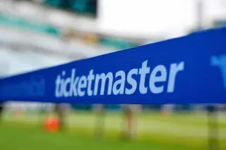 شريط أزرق يحمل شعار "Ticketmaster" في ملعب، يرمز إلى التغييرات المحتملة في بيع تذاكر الحفلات الموسيقية بعد الاتفاق مع الحكومة الأمريكية.